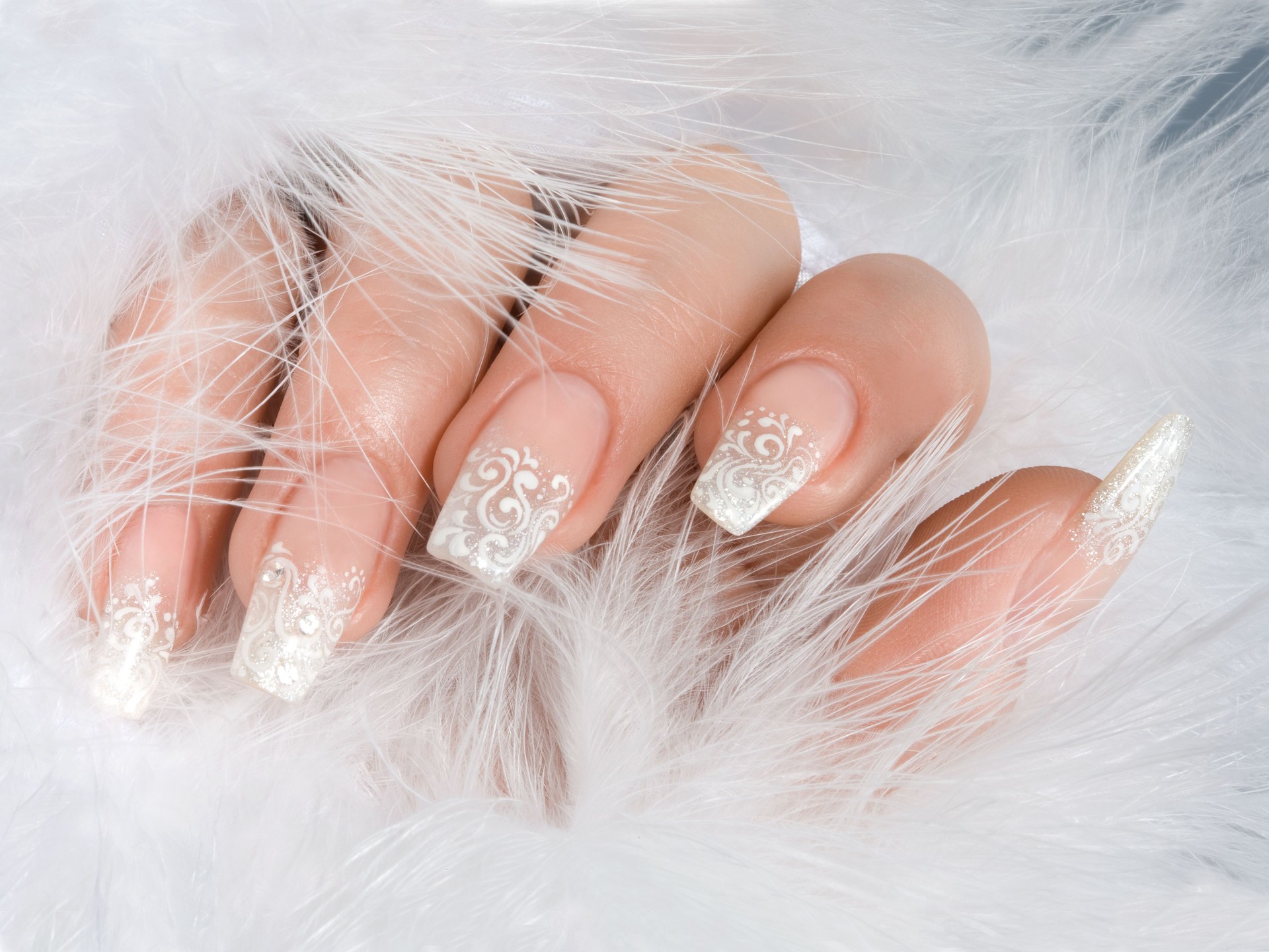Woman's hand with white winter manicure